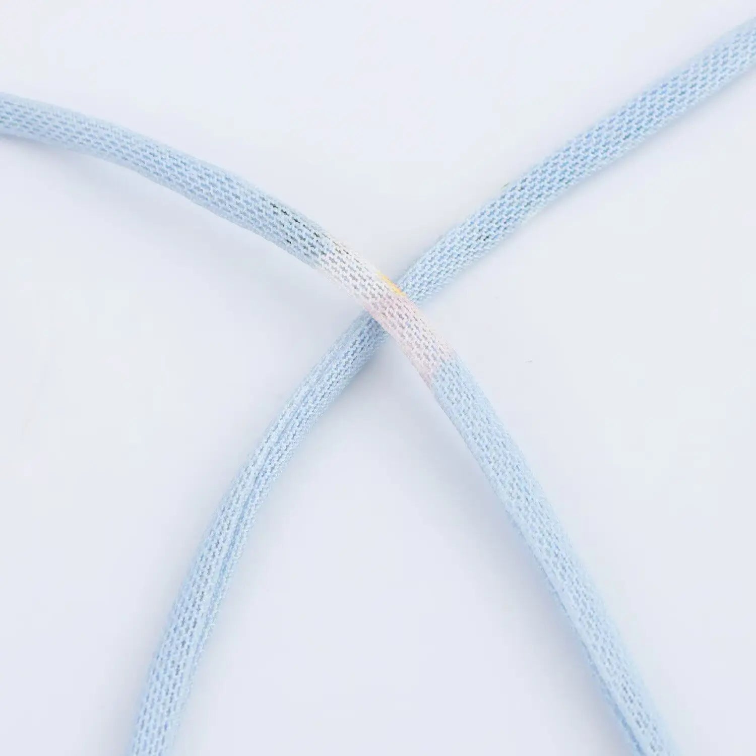 Macro close‑up of thin printed spaghetti strap for light blue floral slip dress