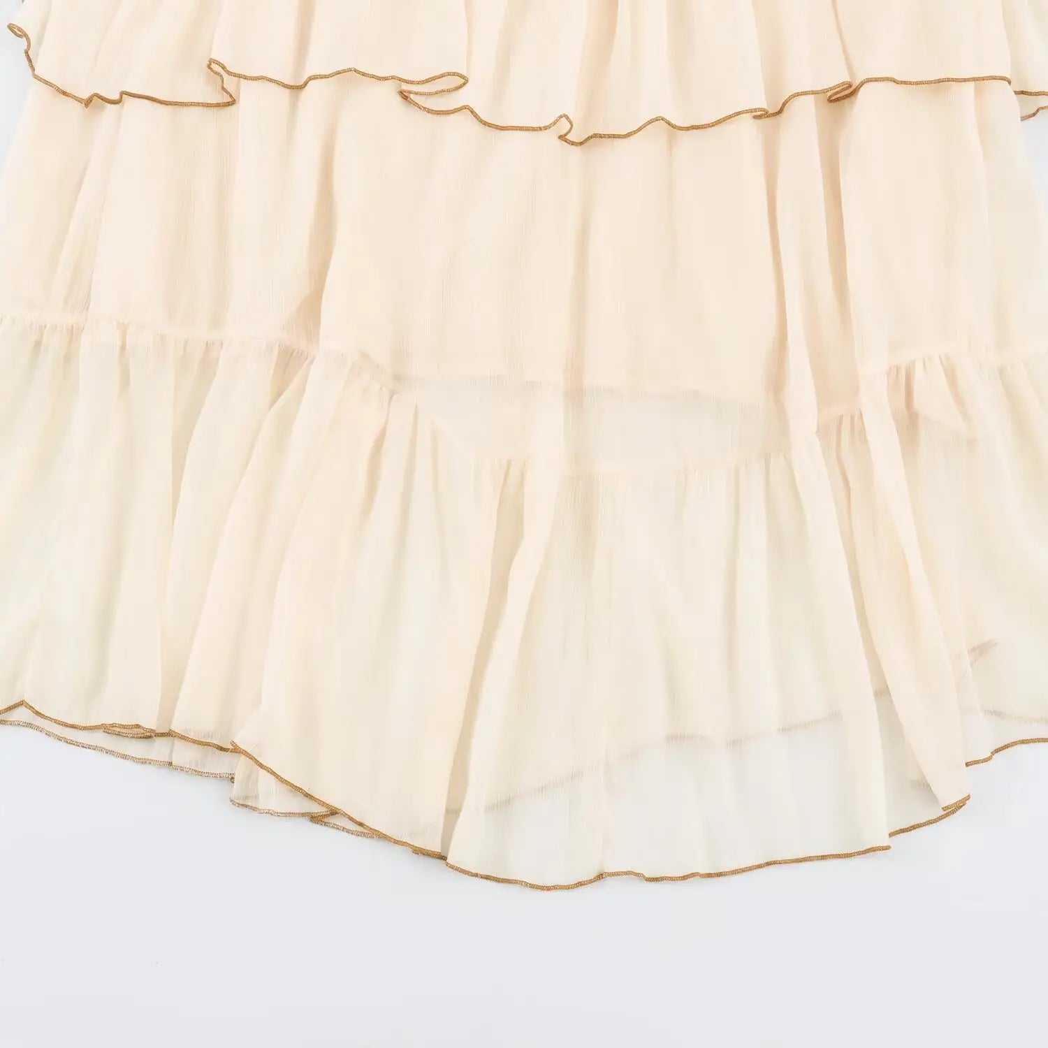 Lower hem view two-layer tiered ruffle skirt with brown piping edge beige maxi dress
