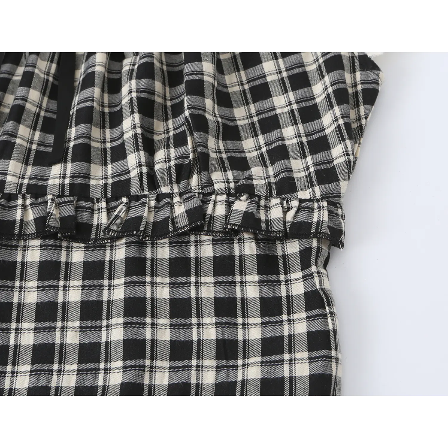 Partial waist close-up two-layer frill ruffle seam on black cream check crop top, gathered plaid fabric tier transition detail