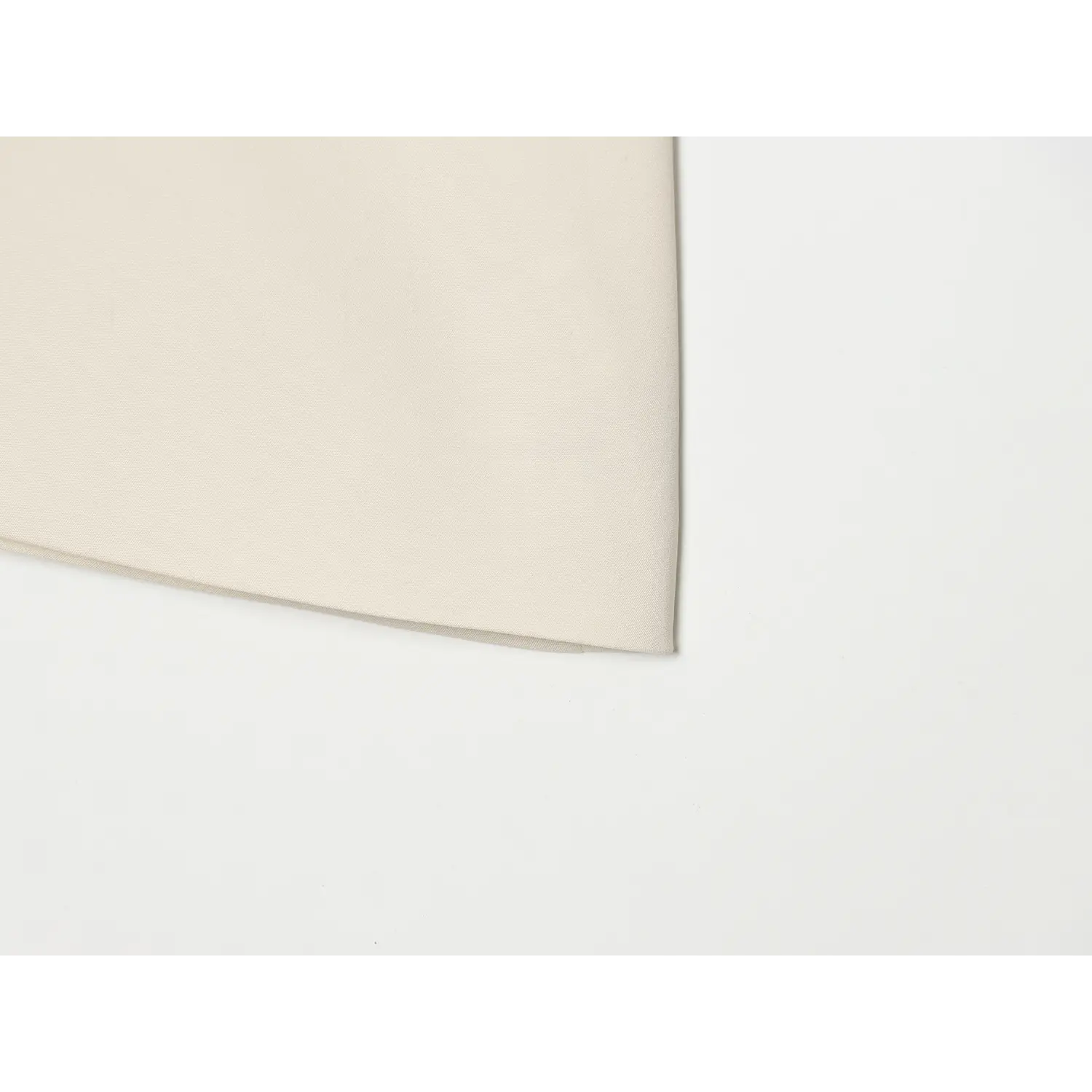 Close-up finished bottom hem fabric of cream halter wrap top