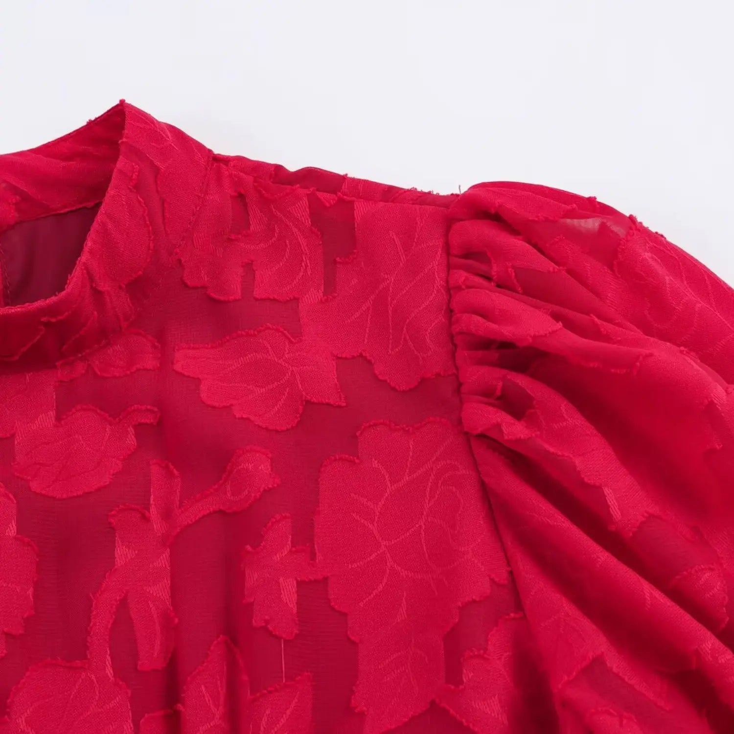 Top shoulder & puff sleeve partial close-up, gathered bubble short sleeve, allover red embossed floral jacquard texture
