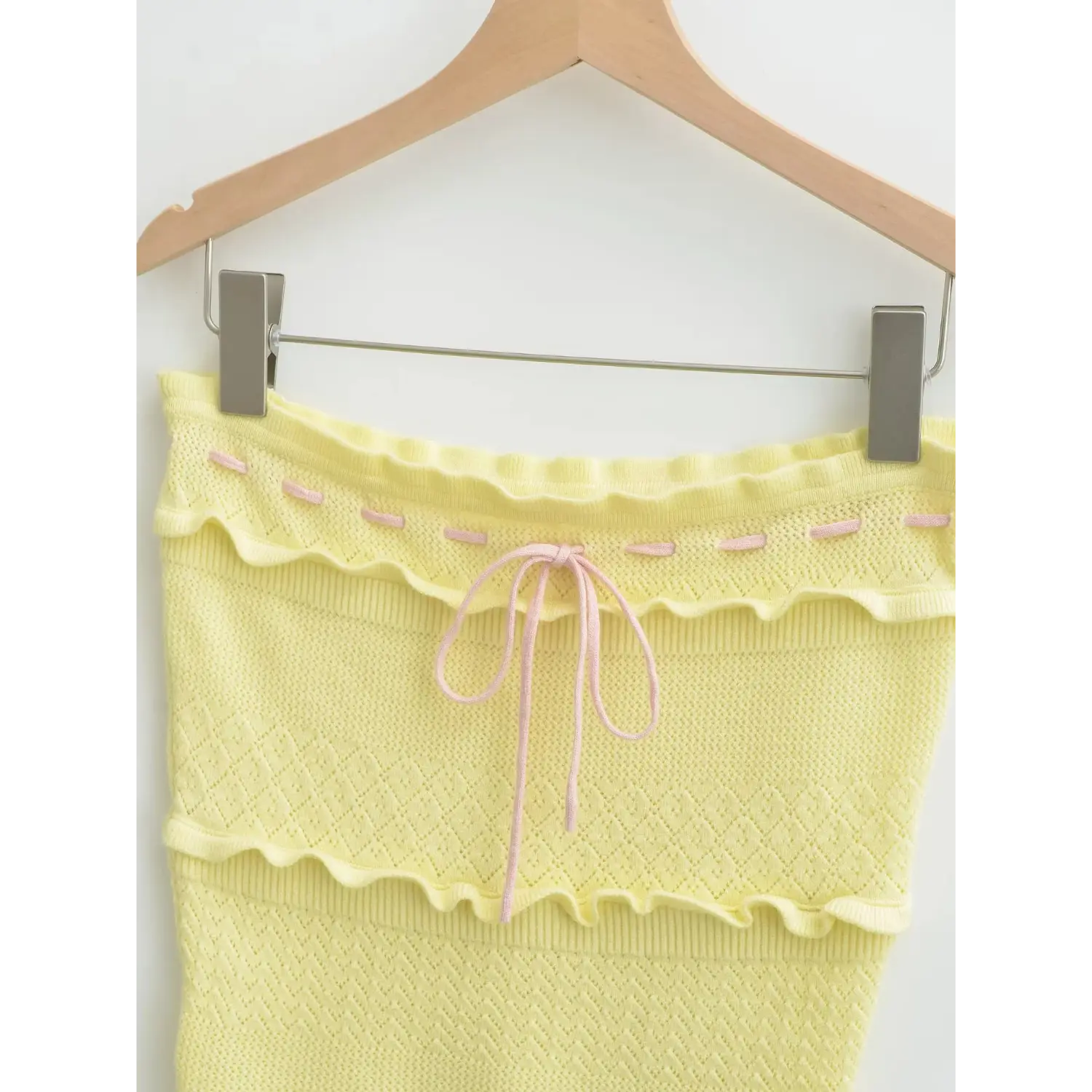 Closeup scalloped ruffle bust band, contrast pink stitching & front tie drawstring