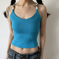 Lifestyle shot of turquoise ribbed camisole with beaded straps and crisscross back
