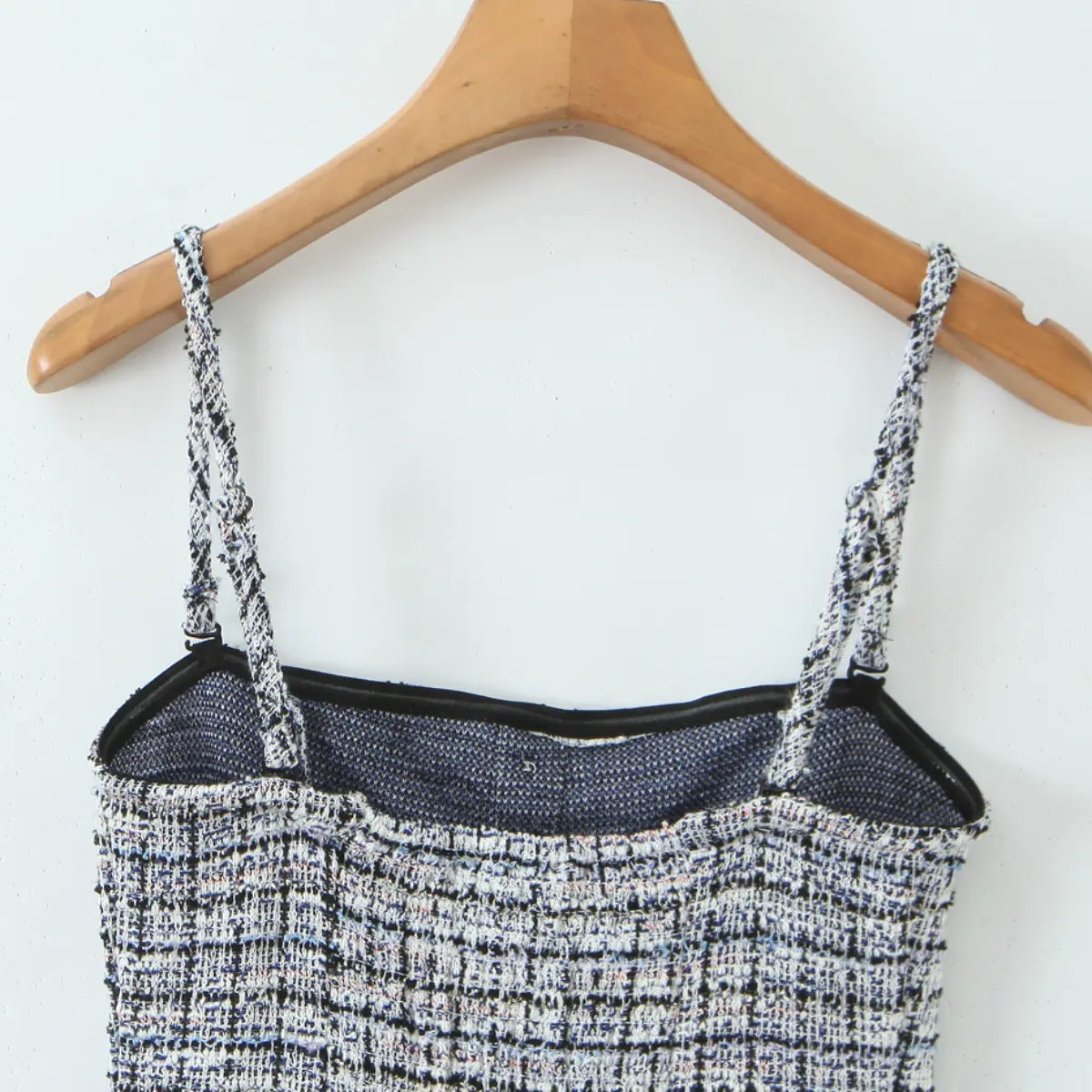 Close-up back view of the tweed cami dress, showing the inner lining and back neckline.
