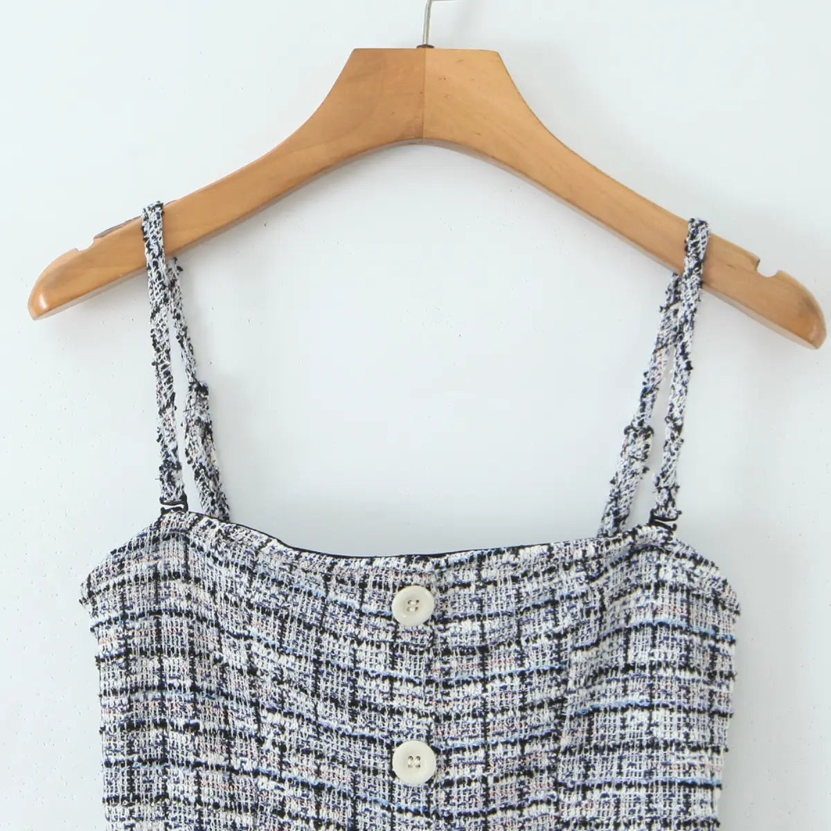 Close-up front view of the tweed cami dress, showing the neckline, straps, and front white buttons.