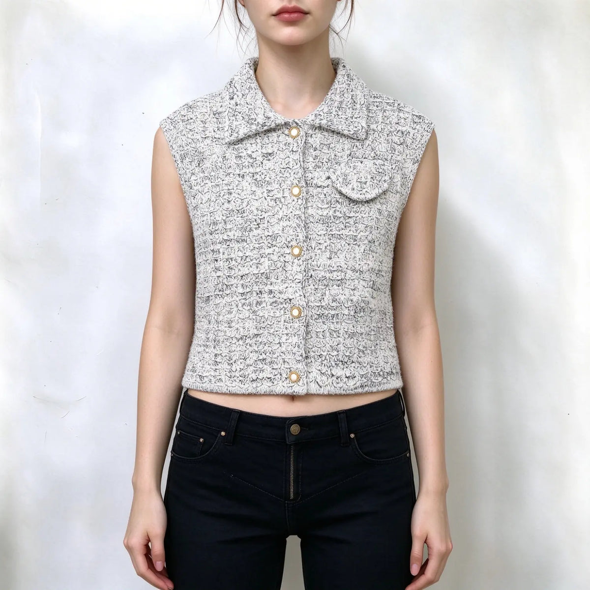 Model wearing tweed collared button cropped vest with black jeans, front view