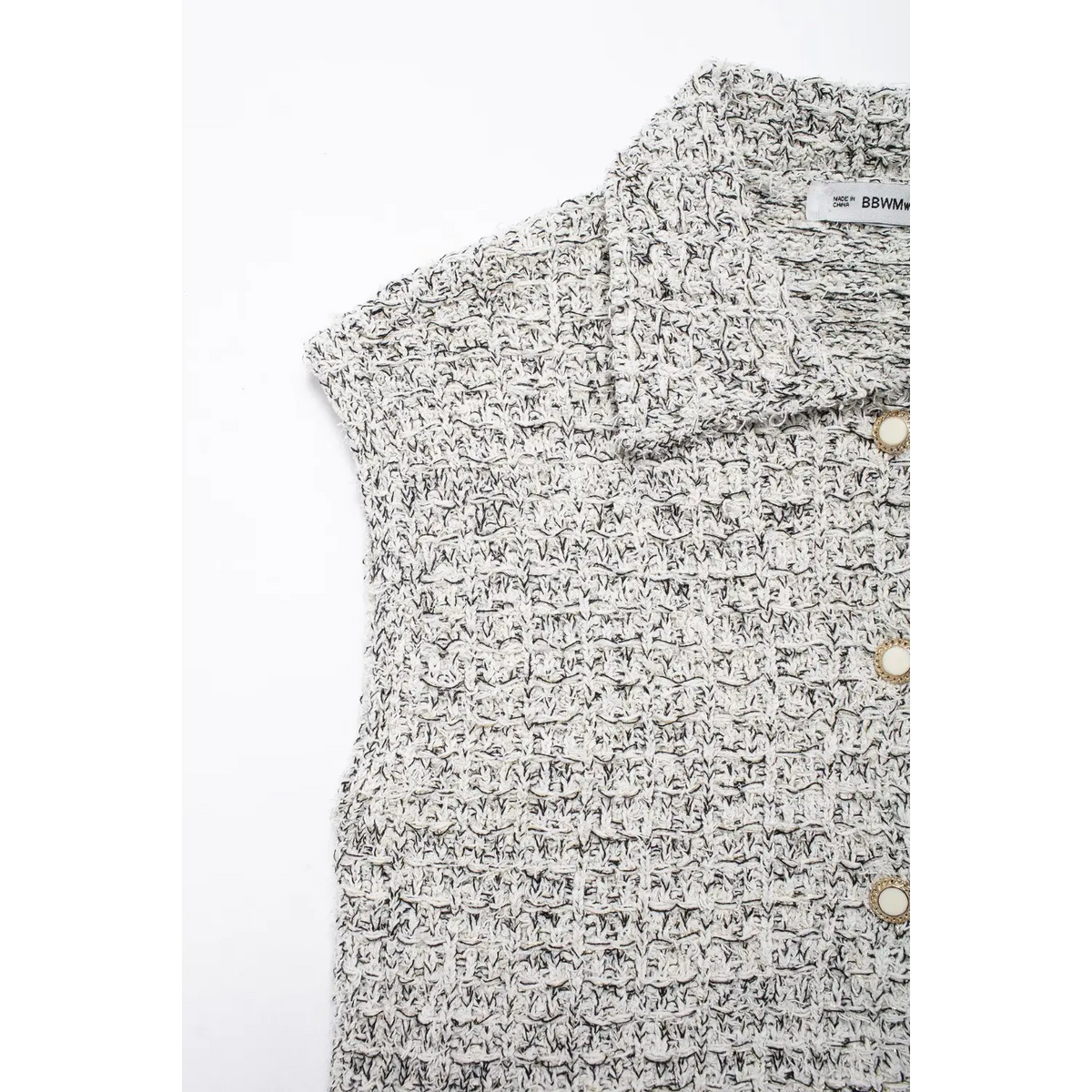 Close-up of shoulder and gold pearl buttons