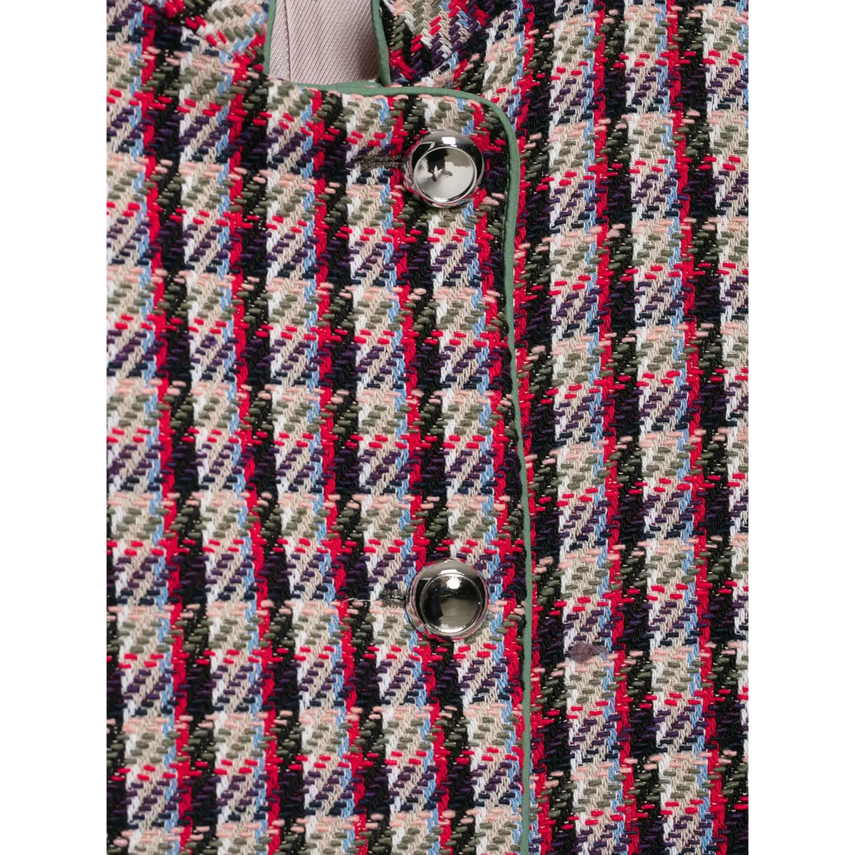 Close-up of plaid tweed fabric with metal buttons, green piping and light lining