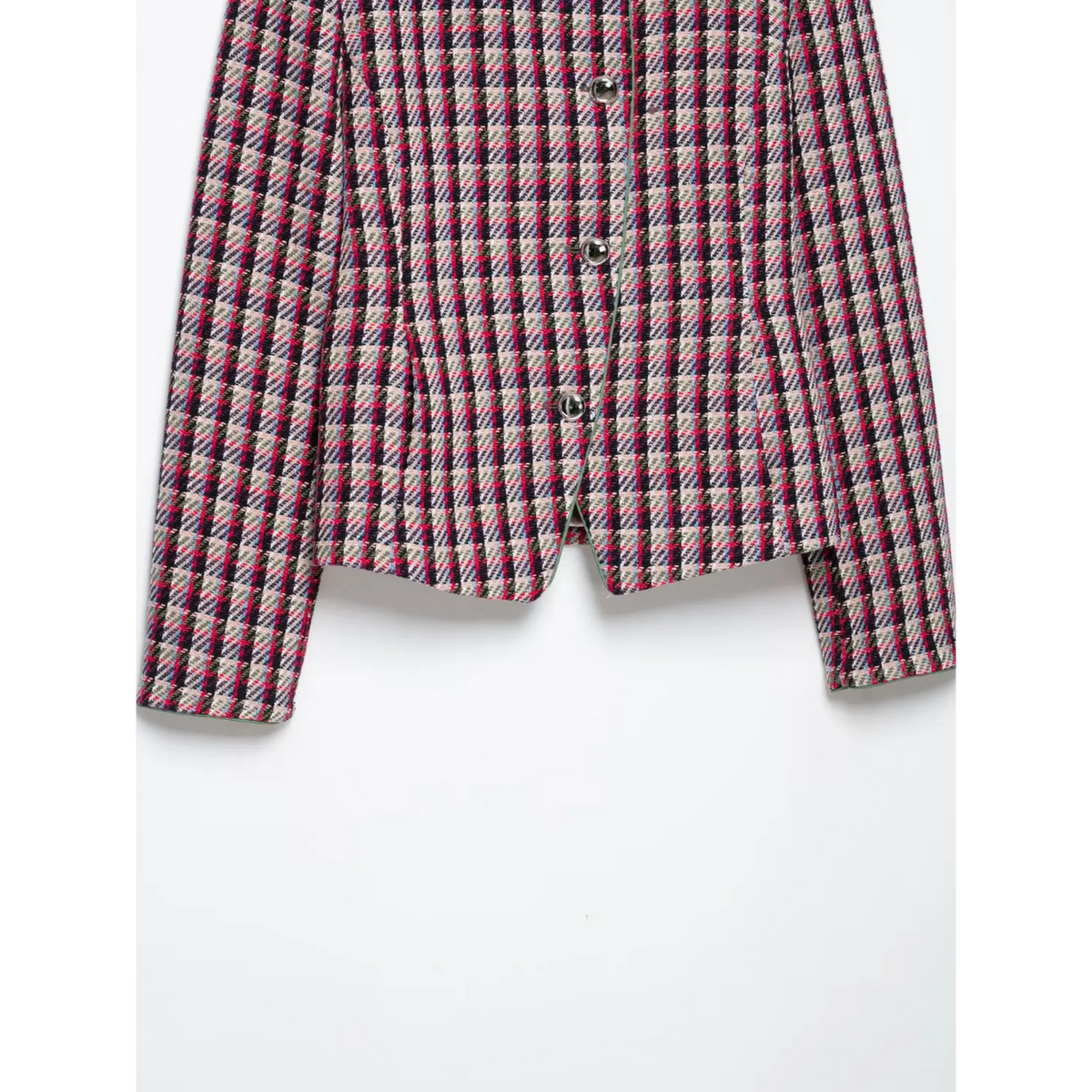 Close-up of front placket with three round metal buttons and green piping trim on plaid tweed jacket