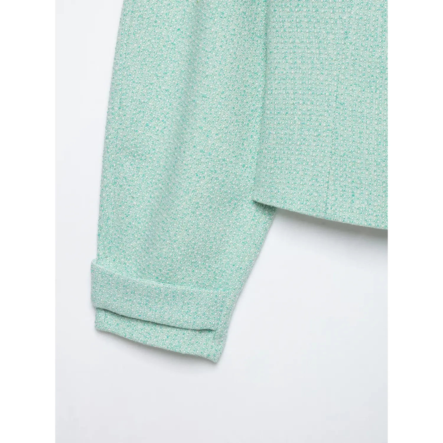 Partial view mint textured woven jacket, rolled cuffed long sleeve and cropped hem detail