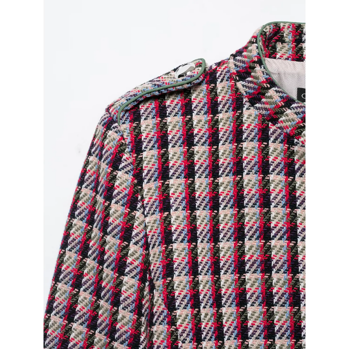Close-up of shoulder epaulette with metal button and green piping on plaid tweed jacket