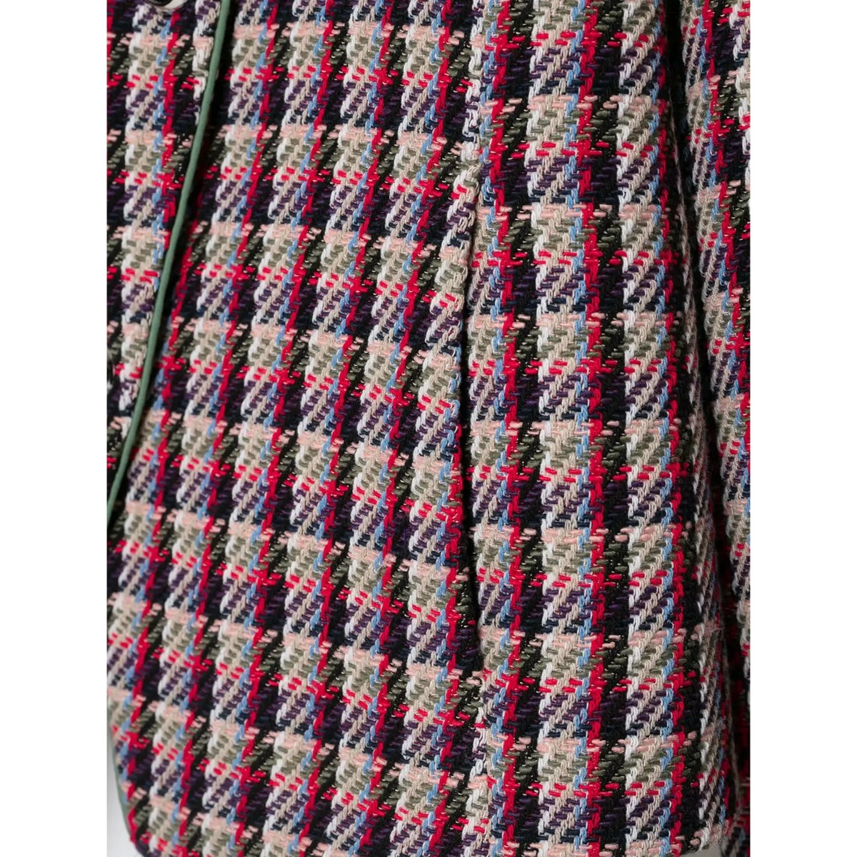 Close-up of diagonal houndstooth weave in red, black, navy and green tones with green trim
