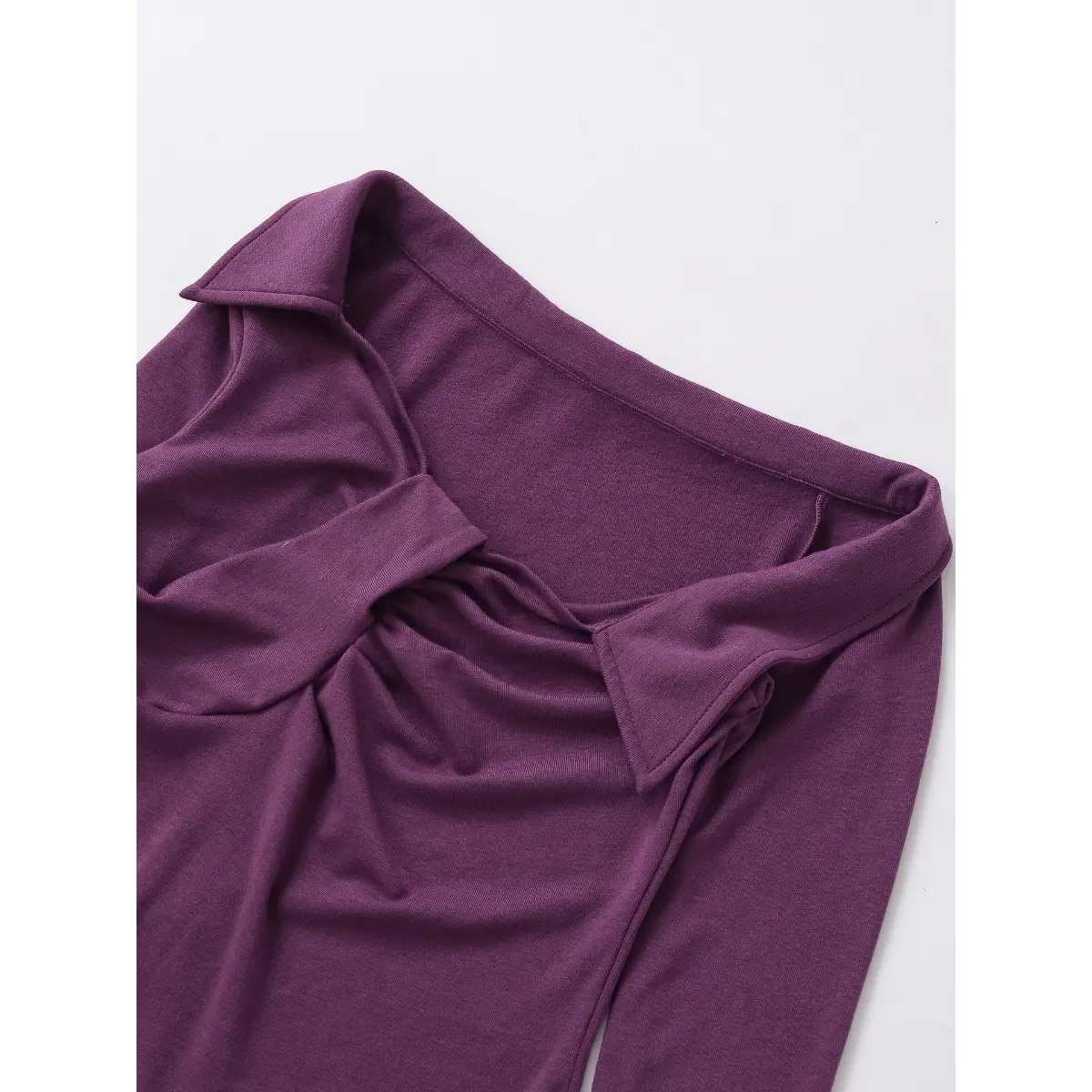 Close-up of the bust area on the purple twist-front top, showing the twisted detail and collar points