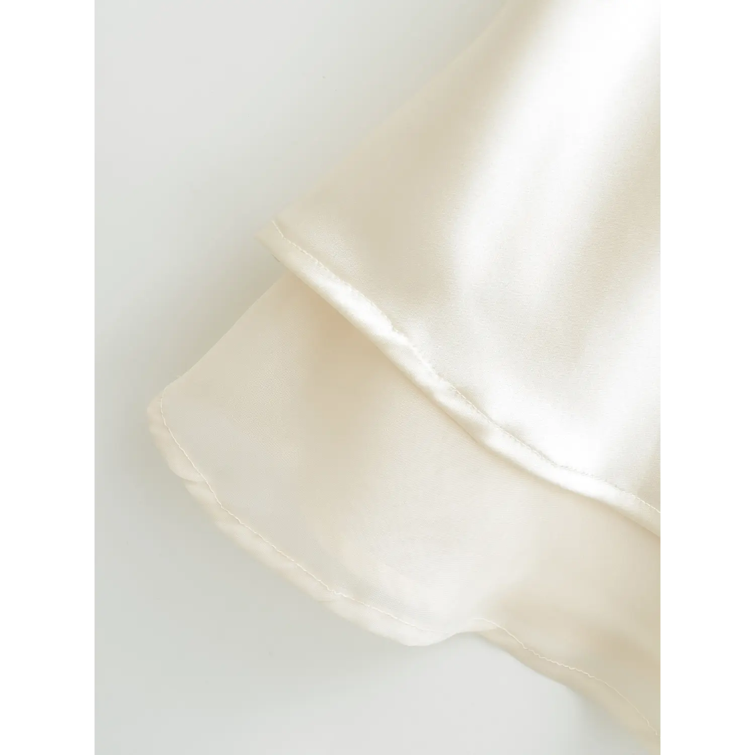 Double hem joint sewing macro close-up, satin & mesh double layer serging even tight stitching lightweight thin hem shot