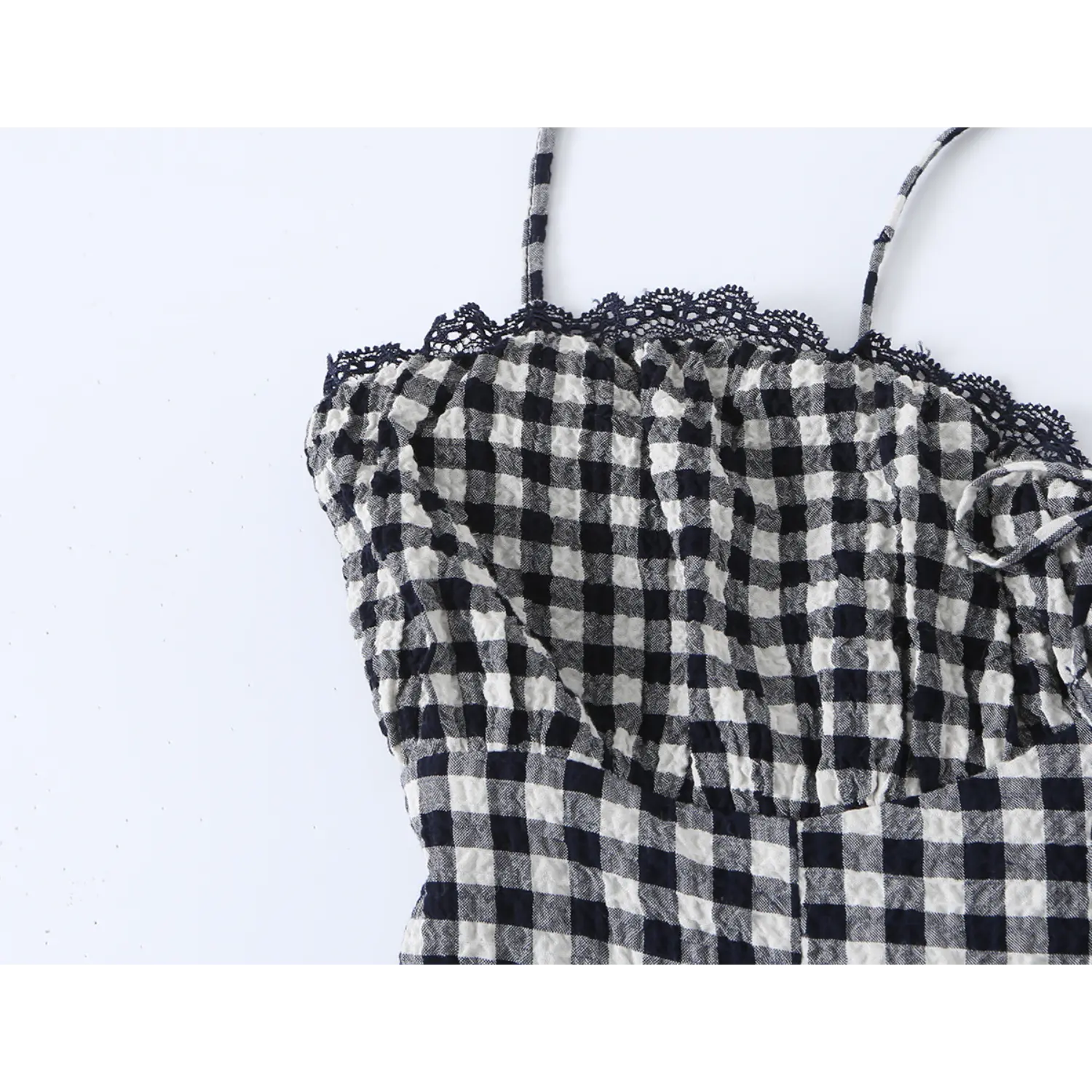 Extreme close-up bust lace scalloped trim, ruched chest fabric texture, thin matching plaid spaghetti strap edge