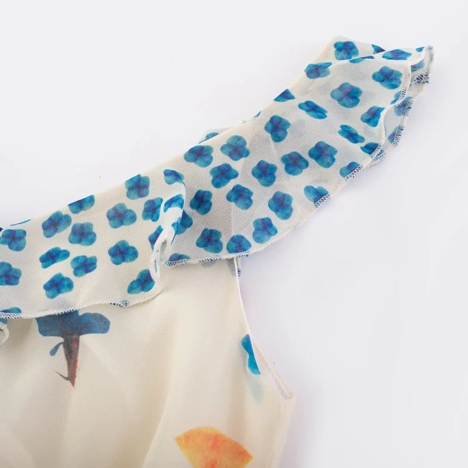 Shoulder partial close-up double layer sheer ruffle strap, light blue polka dot print chiffon, elastic gathered edge spliced to cream floral main fabric