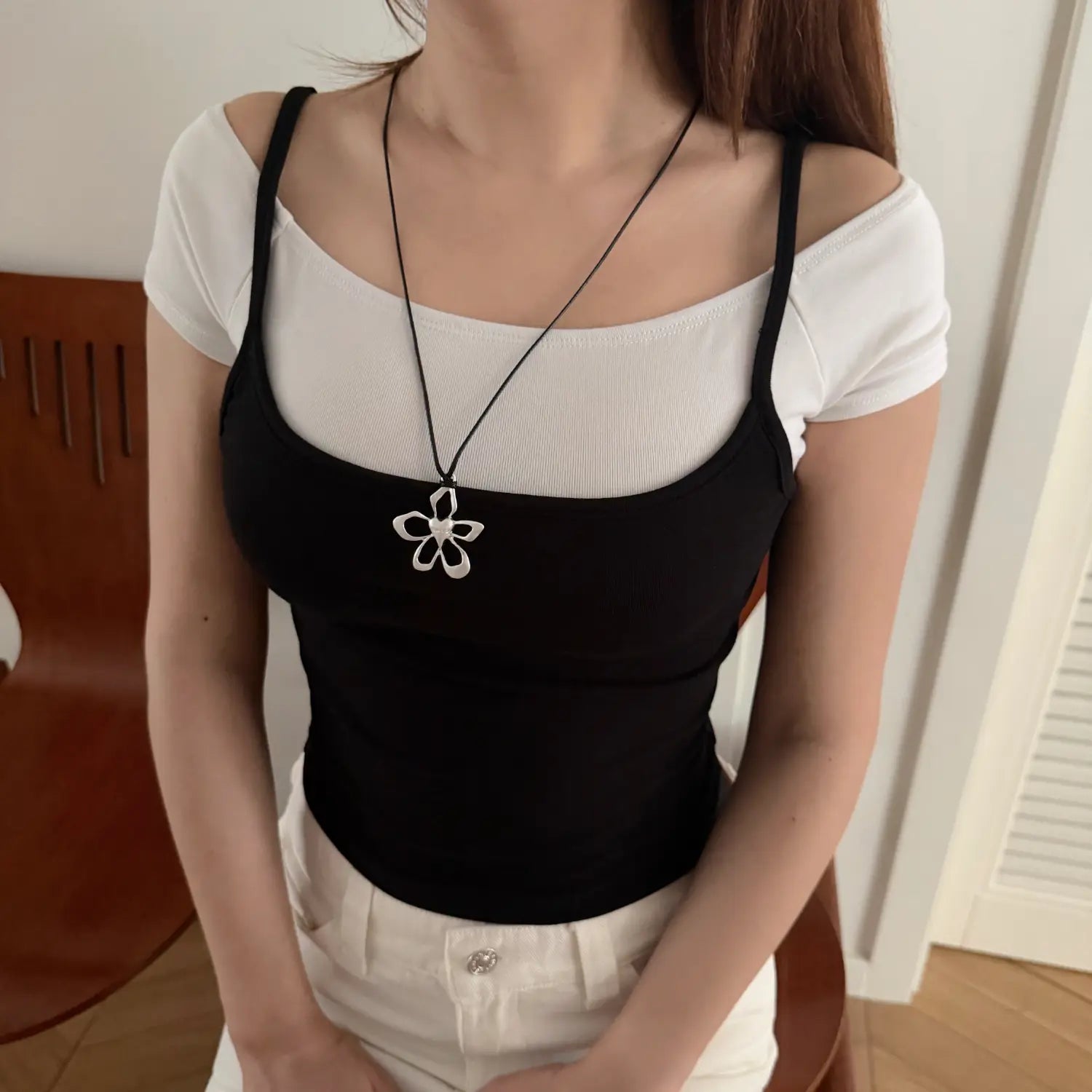 Two tone fake two layered camisole half body model shot with wooden chair background, wide square neck thin straps waist cinched curved hem soft korean girly daily layering piece
