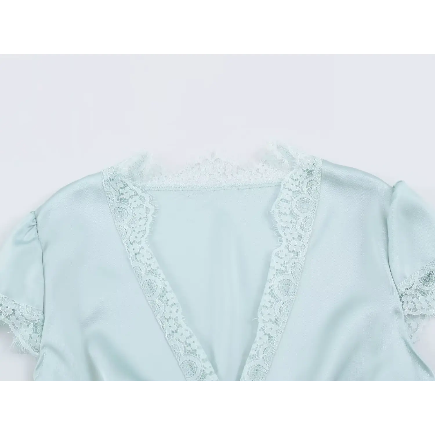 Close-up of eyelash lace v neck detail on light blue satin mini dress