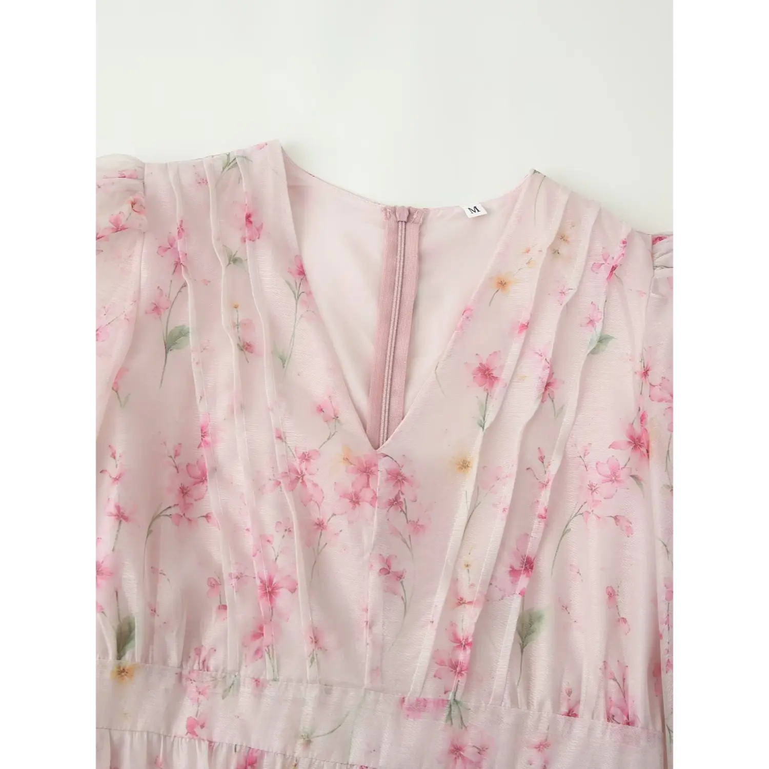 Front neck partial close-up, deep V vertical pleat detail, pink invisible back zipper, soft sheer chiffon floral fabric