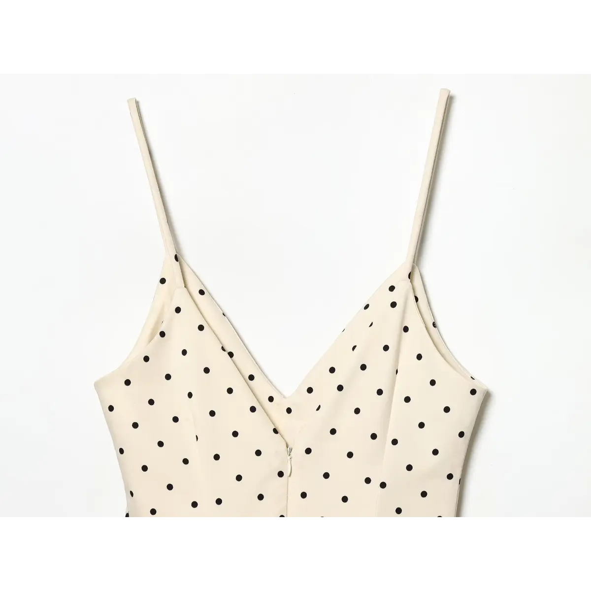  Inner neck seam close of cream dotted dress, finished faced V-neck construction and neat princess seam stitching.