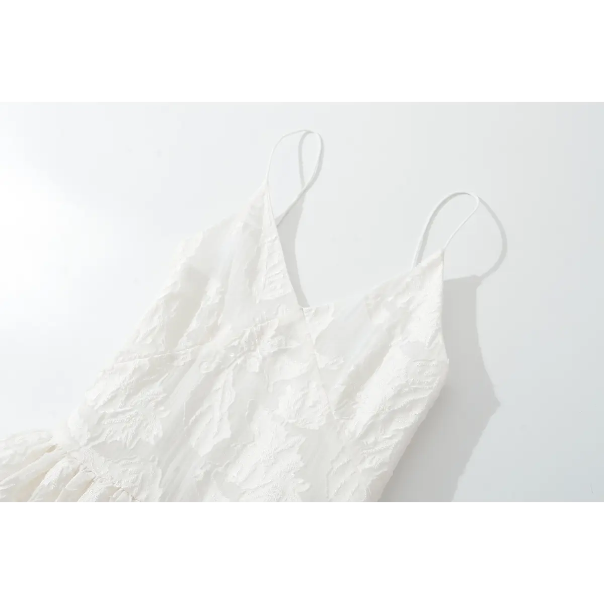 V neckline close of embossed floral white cami mini dress