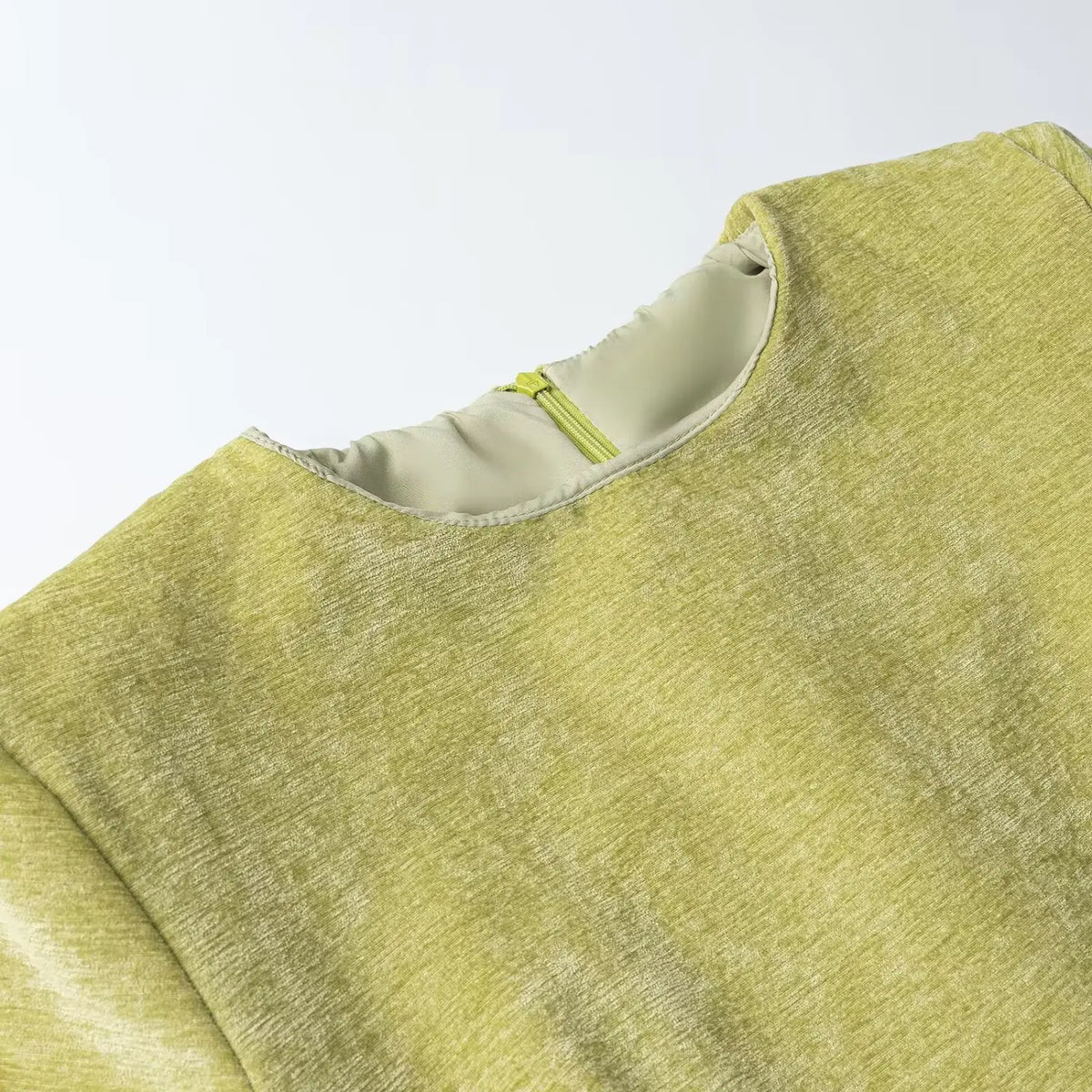 Close-up of green collar and back zipper