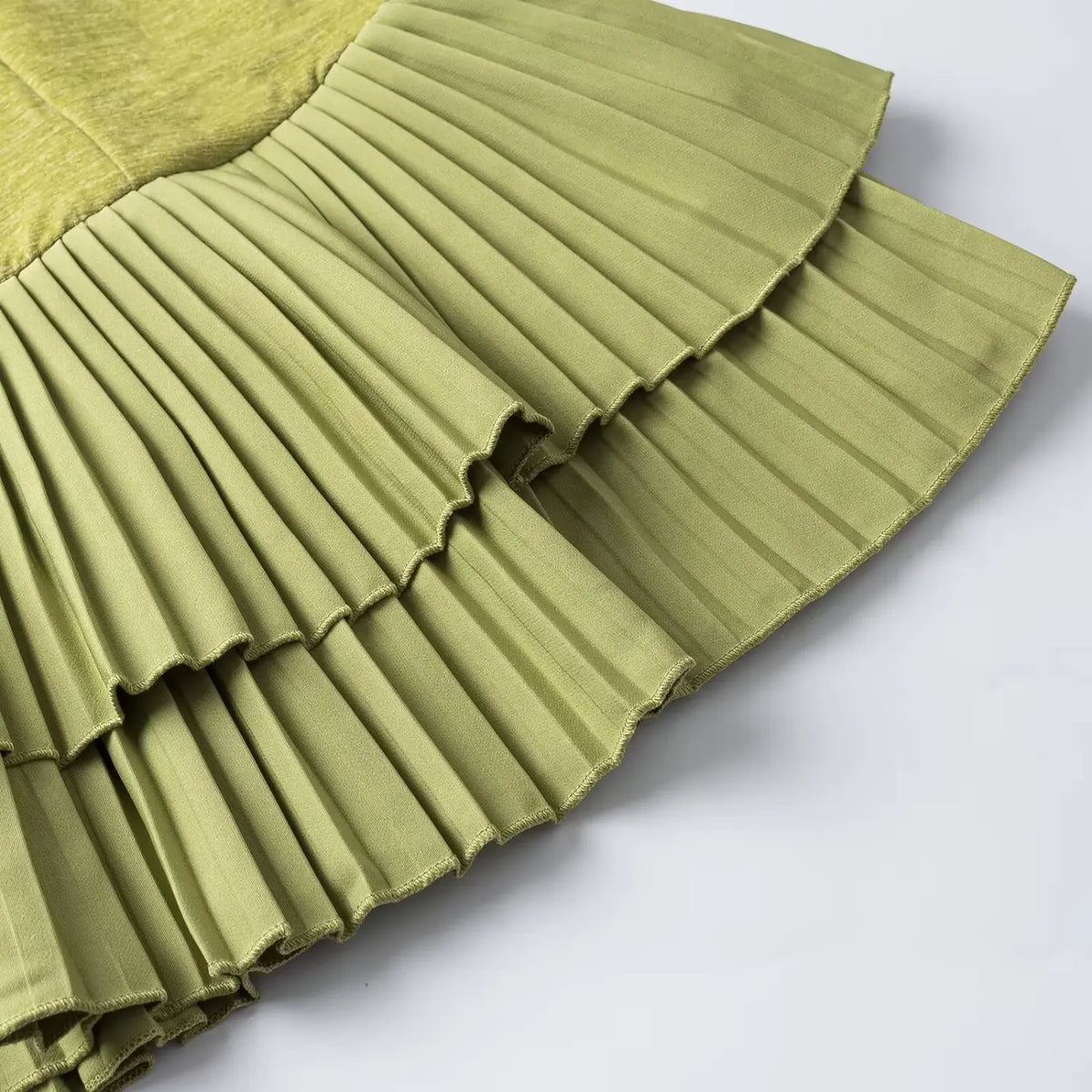 Close-up of green double layer pleated ruffle hem
