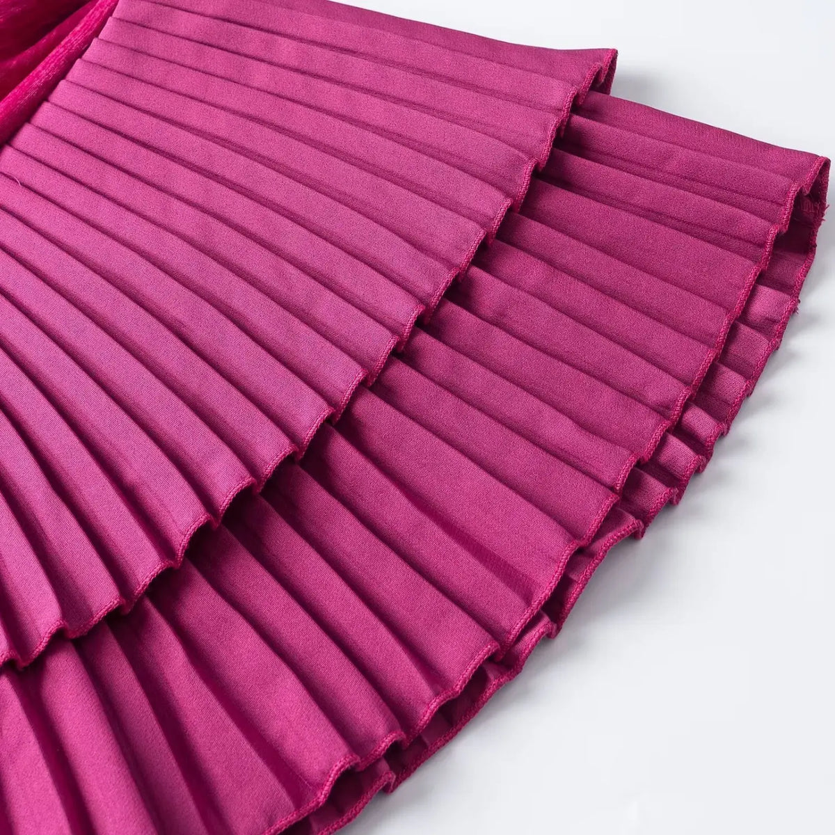 Close-up of fuchsia tiered pleated ruffle hem