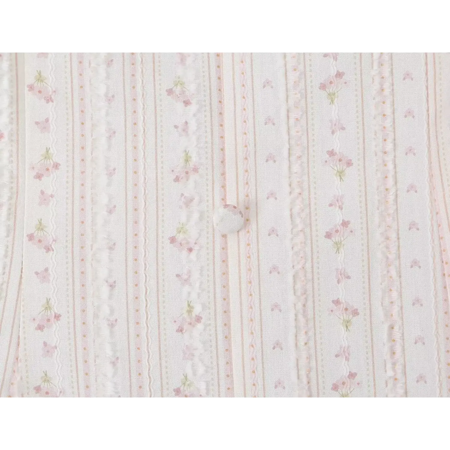 Macro close-up lightweight textured woven fabric, vertical stripe tiny pink floral print, round matching fabric covered bust button detail