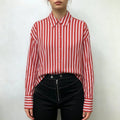 Model wearing navy vertical stripe drop shoulder button down shirt