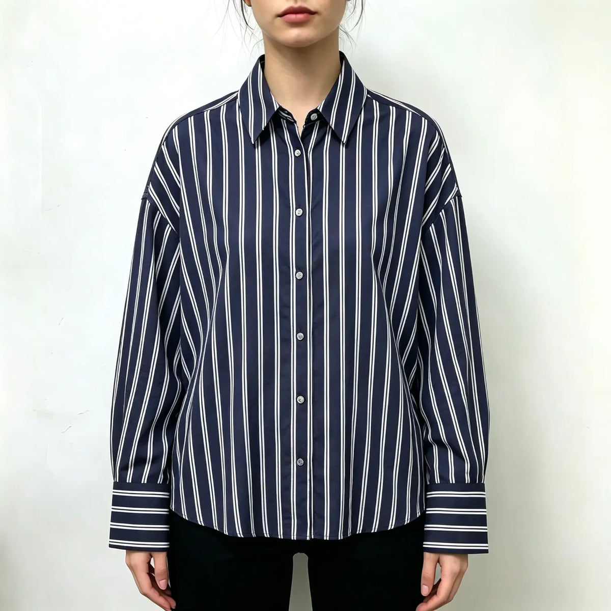 Model wearing navy vertical stripe drop shoulder button down shirt
