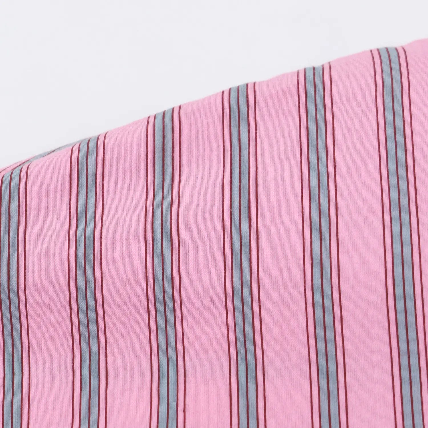 Extreme closeup lightweight soft woven fabric, pink base multi thin vertical stripe print