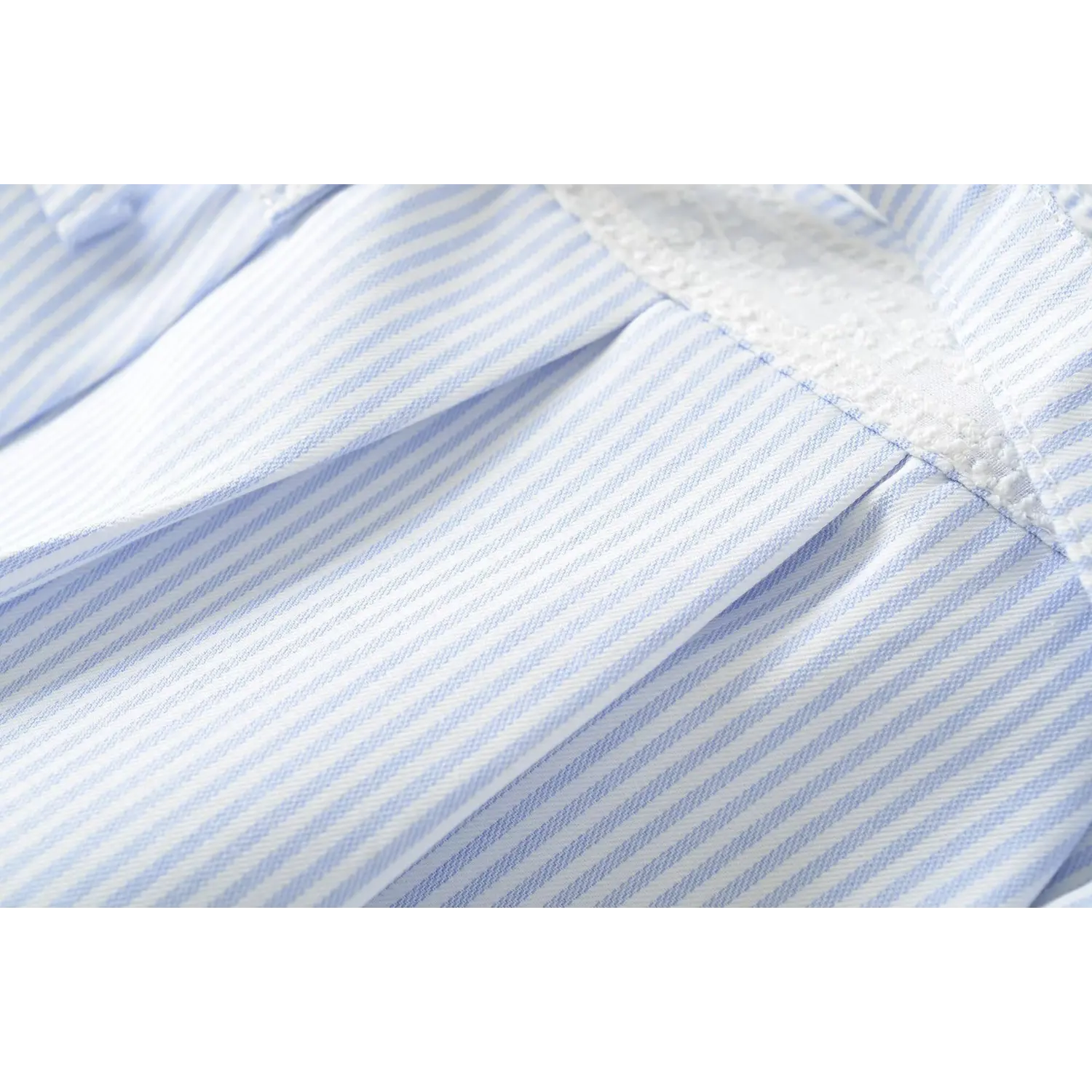 Vertical stripe twill fabric macro close-up, even heat-set pleats anti-wrinkle stiff drape stripe cloth texture shot