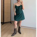 Full front indoor mirror selfie of dark green paisley print slip mini dress, thin adjustable straps, front bust tie detail, styled with brown studded western cowboy ankle boots