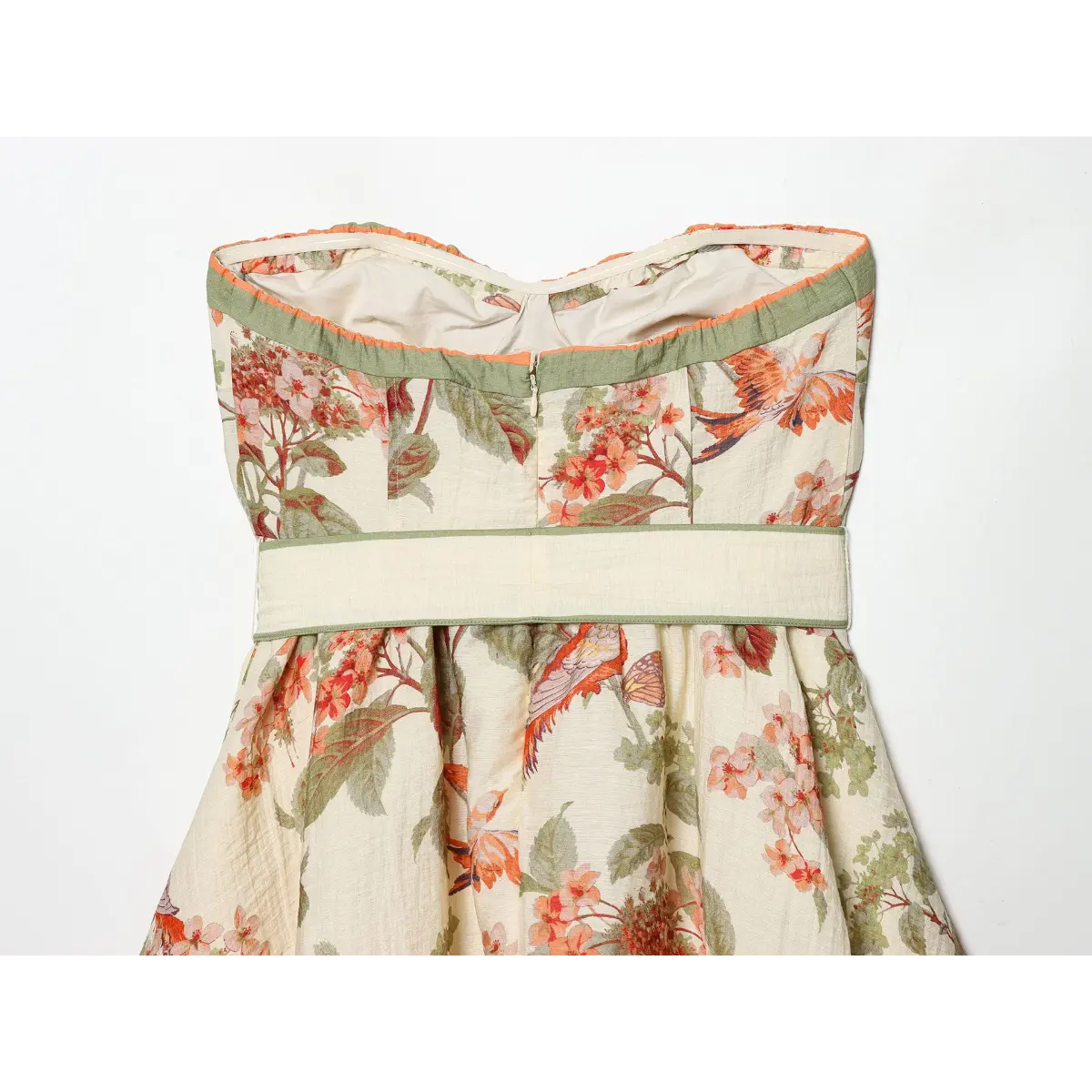 Inner back shot of tube mini dress, elastic top edge, center back hidden zipper and full solid inner lining with allover blossom & bird artwork.