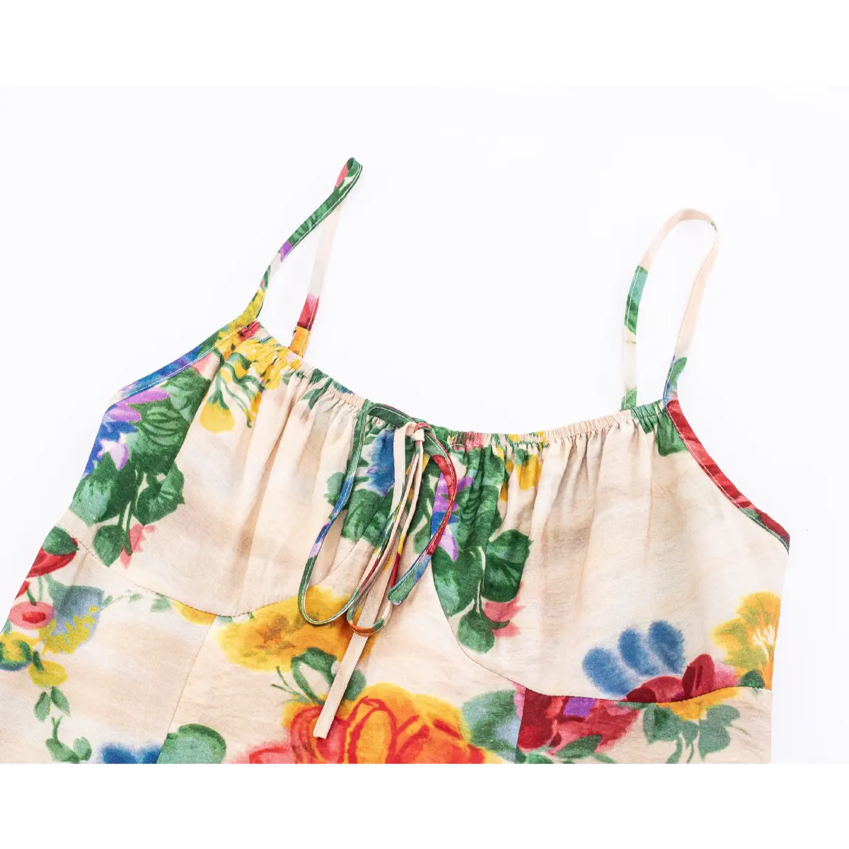 Front bust detail of elastic shirred top with self-tie drawstring and adjustable spaghetti straps.