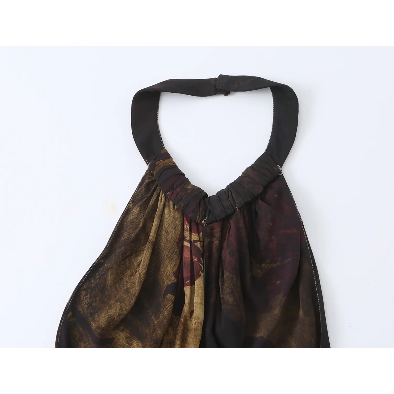 Flat‑lay close‑up of halter dress back neck, gathering fabric and hidden zipper closure
