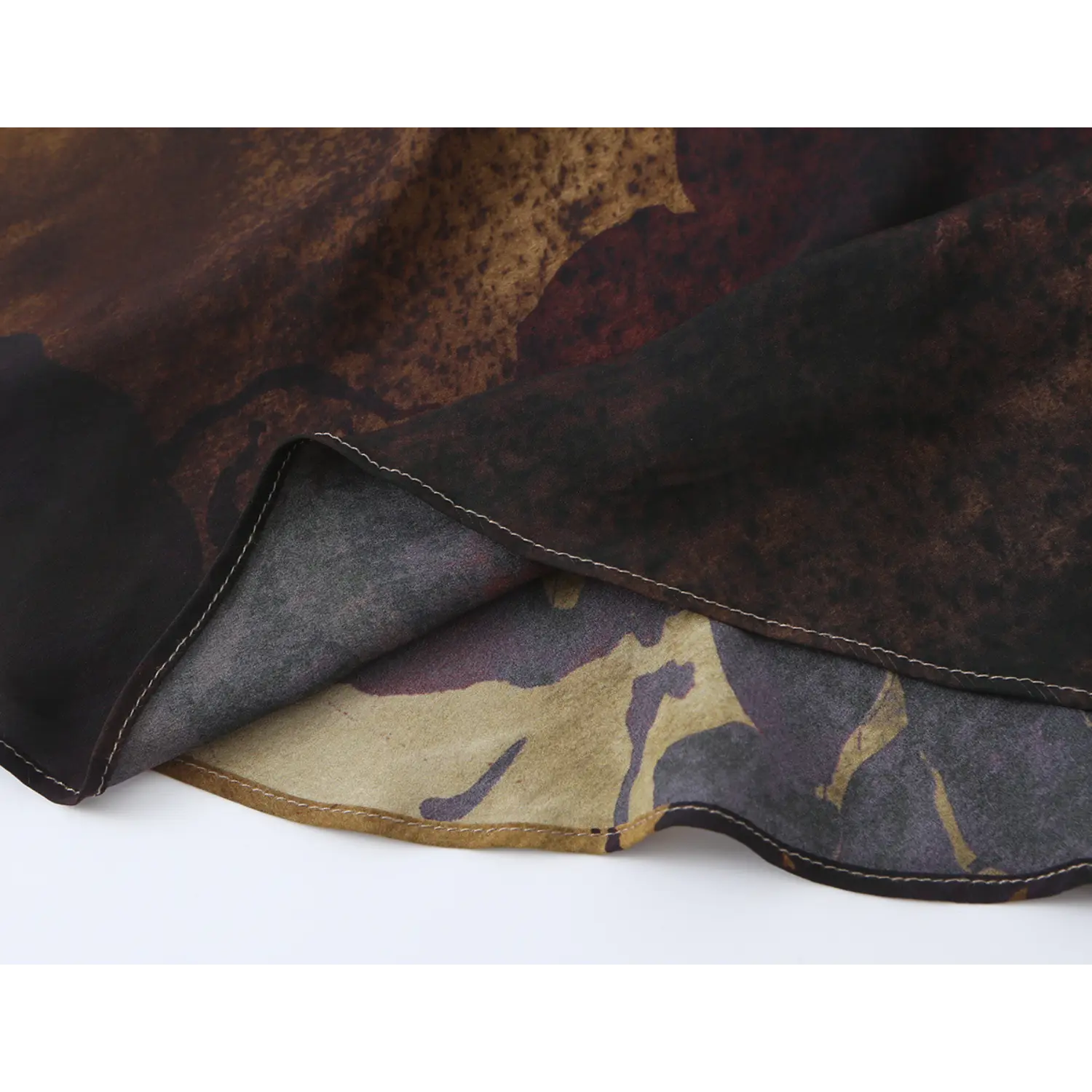 Close‑up of dress hem showing inner lining fabric and double‑stitched finished edge