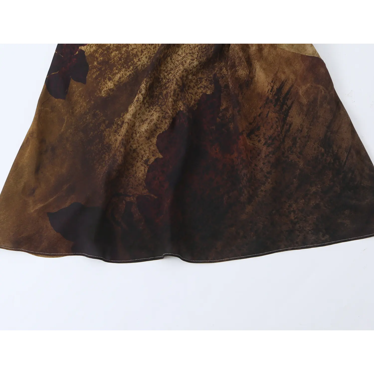 Close‑up of maxi dress skirt hem, vintage sepia floral print and neat finished stitching