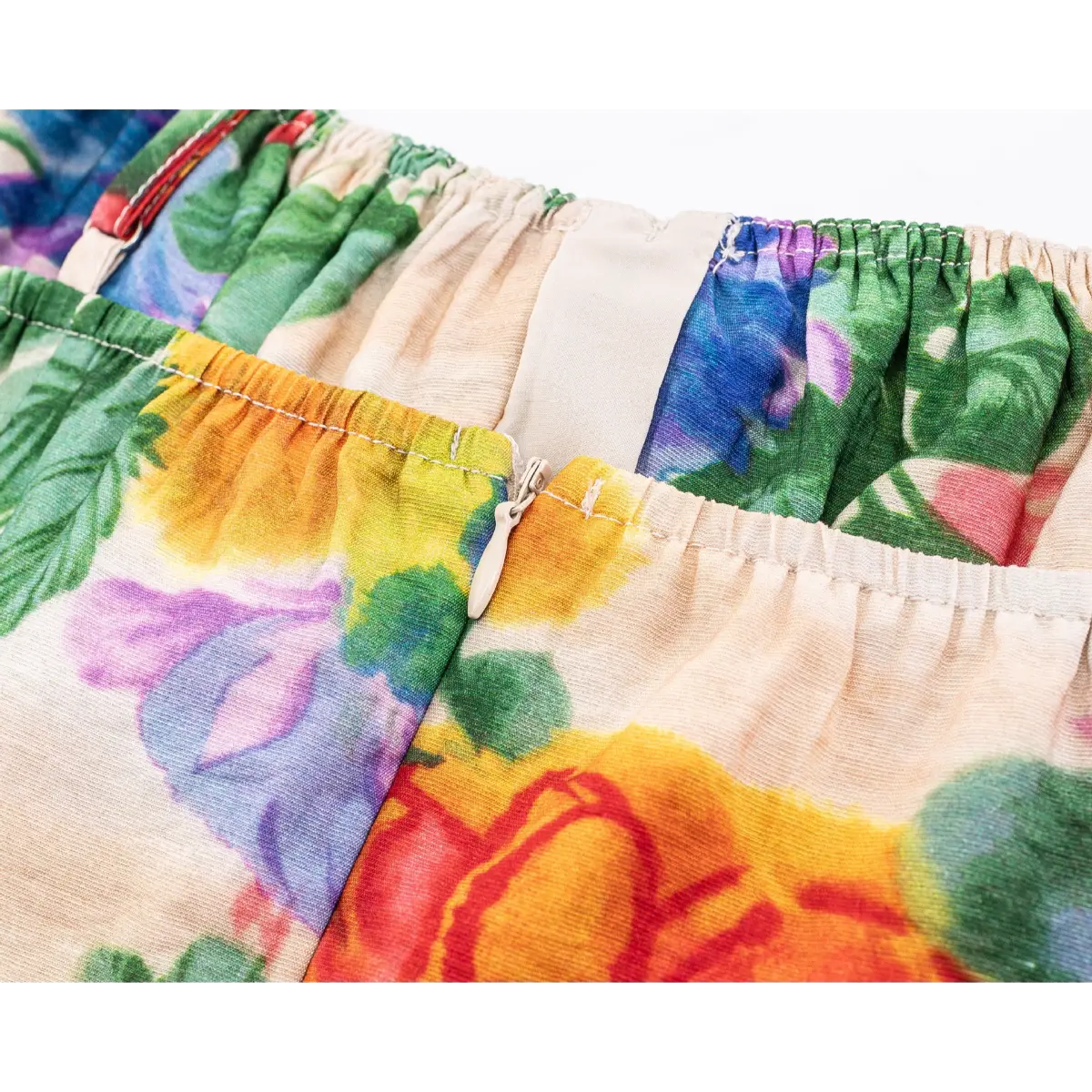 Close-up of invisible side zipper set into elasticated floral fabric panel.