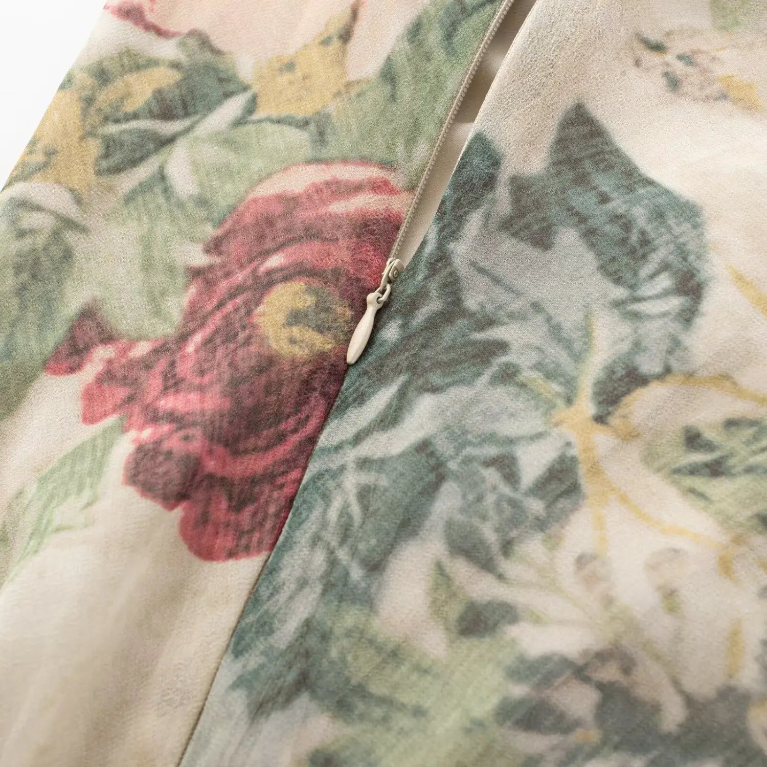 Extreme close‑up side invisible zipper detail on vintage rose floral print mini dress
