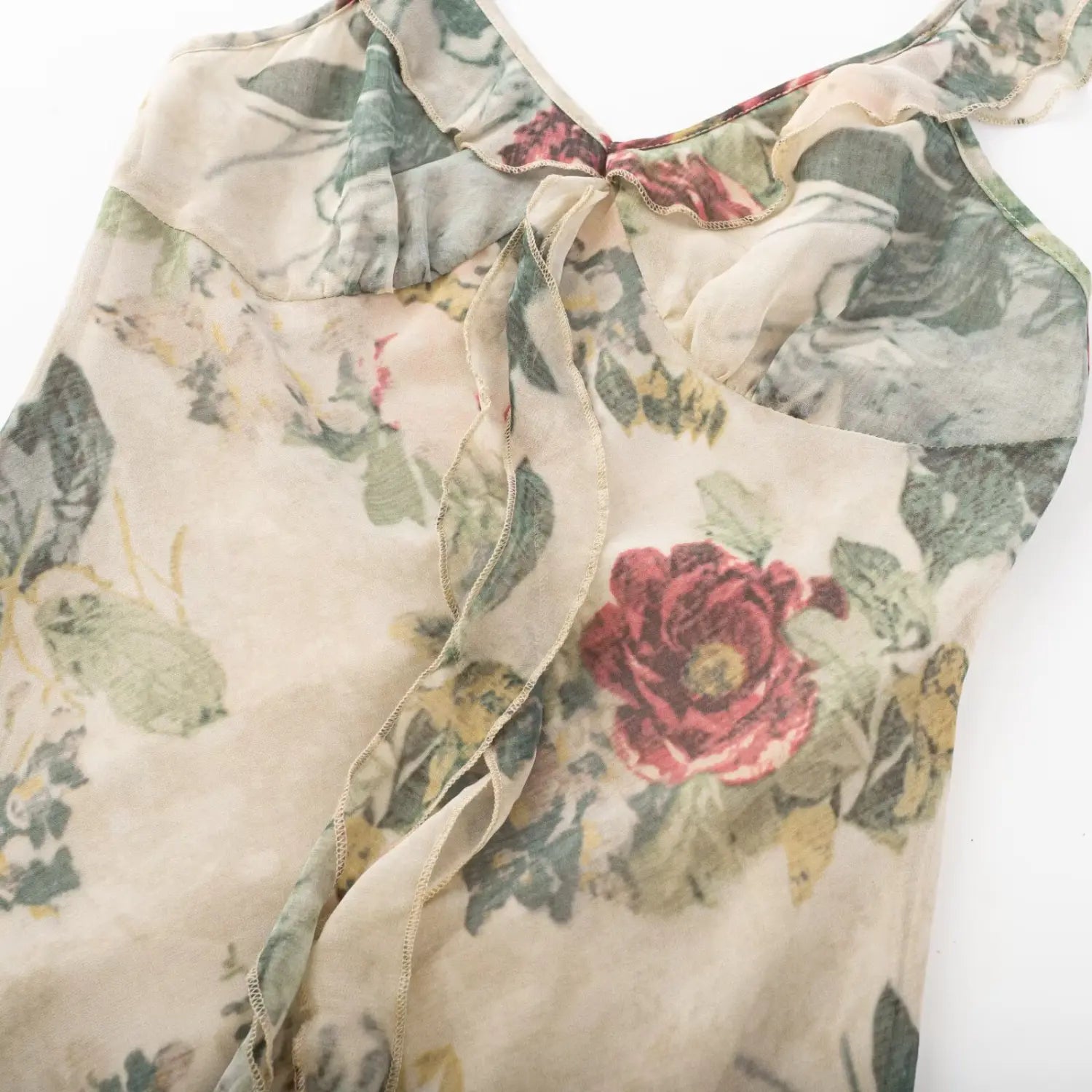 Close‑up flat shot vintage floral mini dress v‑neck bust with ruffle trim and front tie mesh fabric