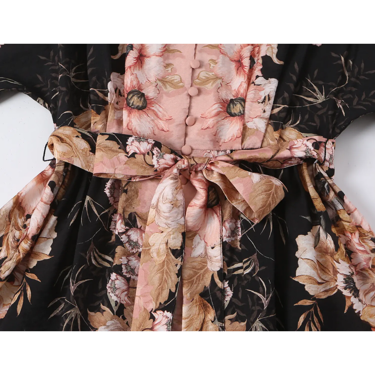 Close-up of self-fabric tie waist bow and gathered skirt