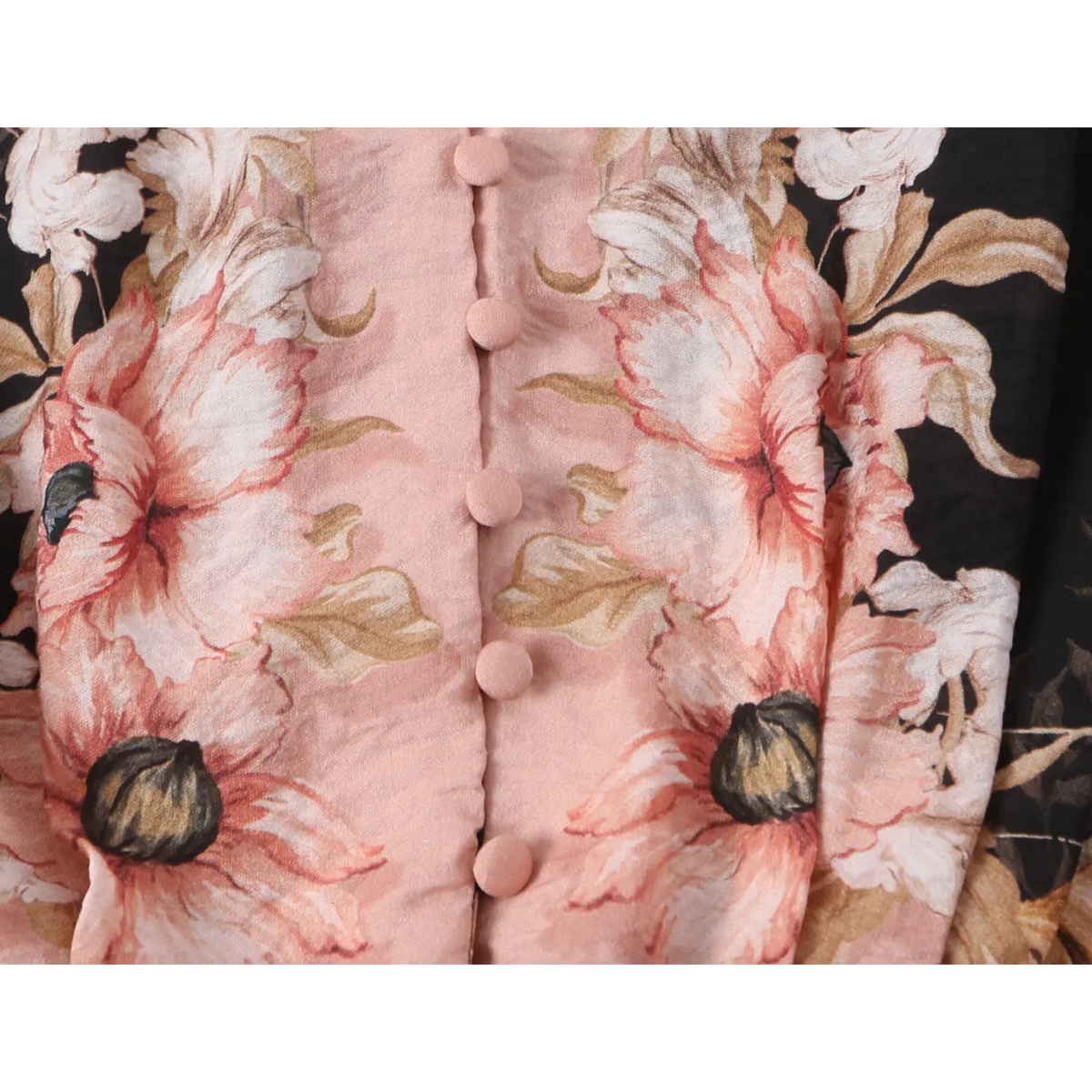 Close-up of pink covered buttons on contrast placket