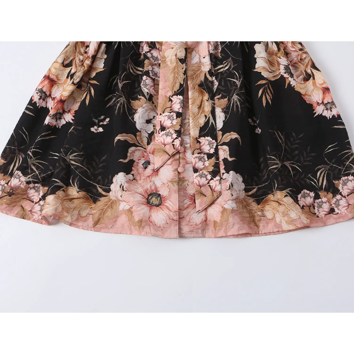 Close-up of pink contrast hem band and mini skirt edge