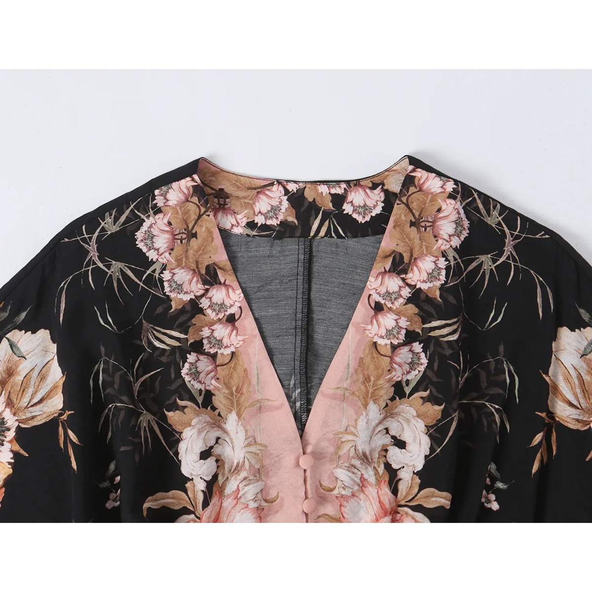 Close-up of V neckline and pink contrast button placket
