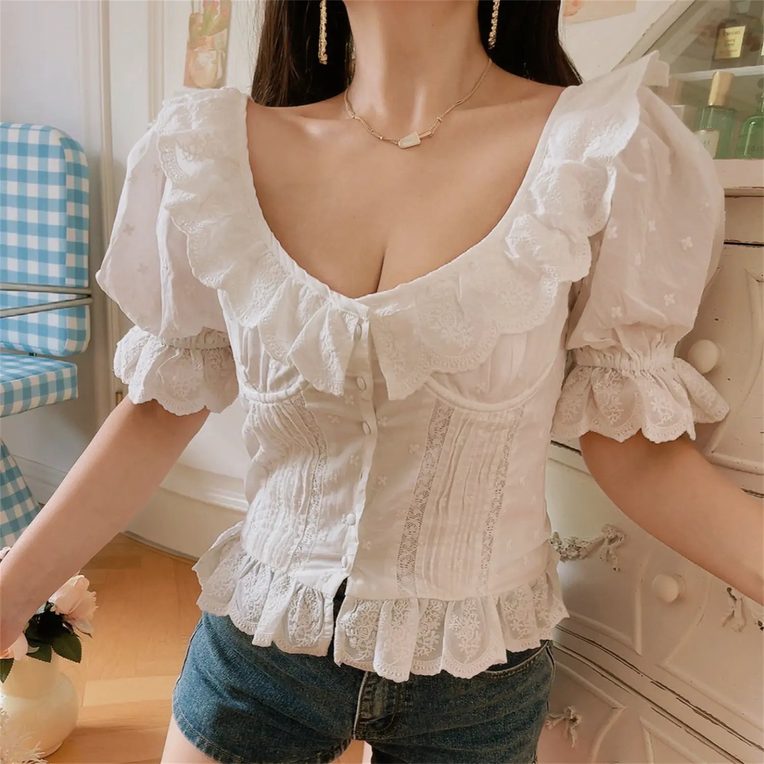 Full front lifestyle view white eyelet embroidered corset top, front button placket, elastic puff sleeve ruffle hem cottagecore blouse