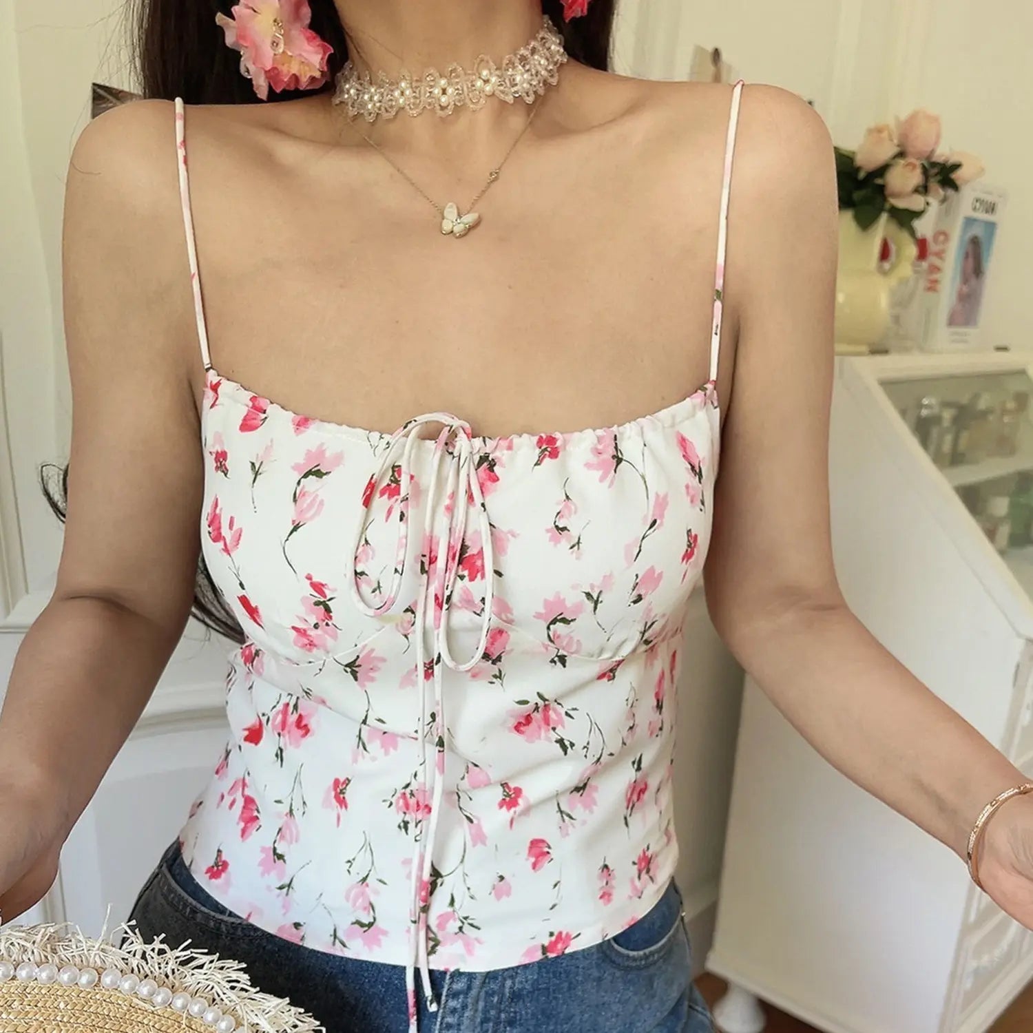 Vintage pink watercolor floral cami crop top, long adjustable front tie elastic neckline, low angle full indoor model wearing shot