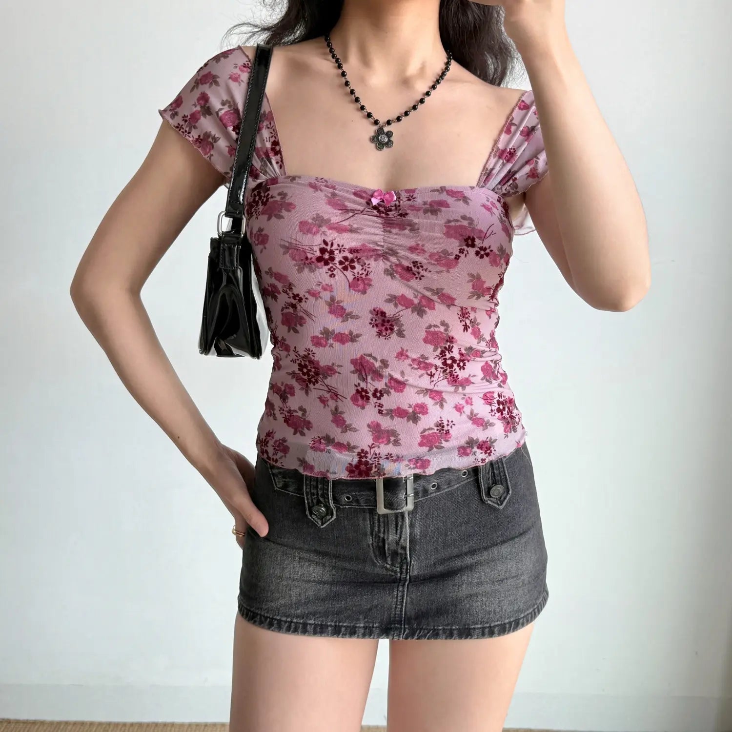 Full length indoor shot of casual coordinate, mauve floral mesh fitted top + denim mini skirt, sweet vintage daily look
