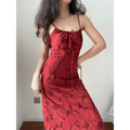Standing indoor lifestyle picture of warm red abstract floral midi dress, waist tailored slim cut and flowy skirt for romantic date style.